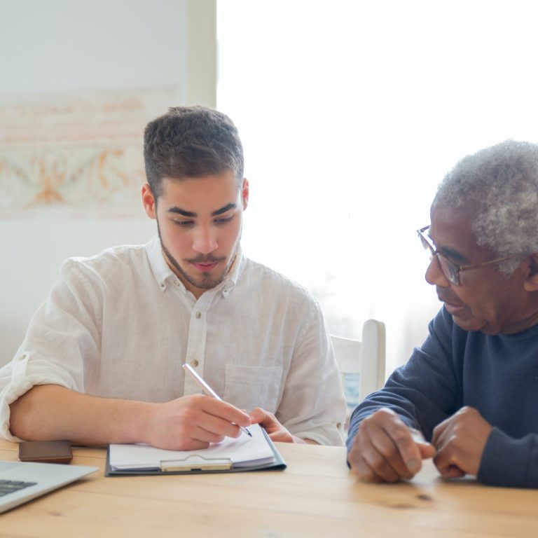 A social worker assisting an elderly client.